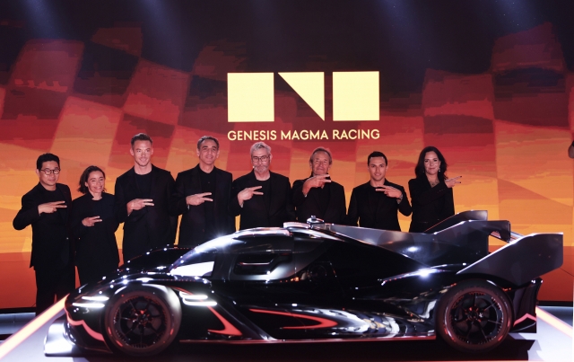 Hyundai Motor officials, including Chief Design Officer Luc Donckerwolke (fourth from right), pose with the GMR-001 Hypercar, the prototype of Genesis Magma Racing's new high-performance racing car, at the Armani Hotel Dubai, United Arab Emirates, Wednesday. (Hyundai Motor Group)