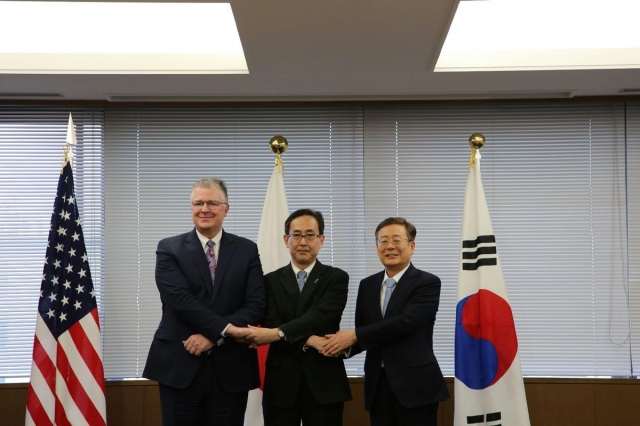 South Korea's Vice Foreign Minister for Strategy and Intelligence Cho Koo-rae; Hiroyuki Namazu, director general for Asian and Oceanian affairs at Japan's foreign ministry; and Assistant Secretary of State for East Asian and Pacific Affairs Daniel Kritenbrink, pose for a photo ahead of their talks in Tokyo on Monday, as provided by South Korea's foreign ministry.