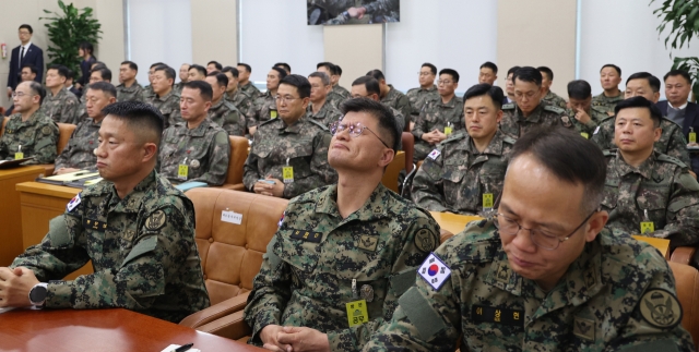 Military officers look somber during a plenary session of the National Assembly’s defense committee on Tuesday afternoon, as questions about the military during martial law imposition continue. (Yonhap)